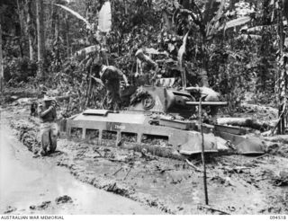 TOROKINA, BOUGAINVILLE, 1945-08-02. LIEUTENANT WOOD PHOTOGRAPHING THE EXTENT OF THE BOGGING OF A MATILDA TANK, WHICH IS TAKING PART IN TRIALS OF THE M24 GENERAL CHAFFEE LIGHT TANK, CONDUCTED FOR ..