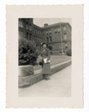 Woman in front of brick building