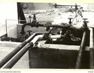 PORT MORESBY, PAPUA, 1944-02-26. DISTRIBUTION CONTROL POINT SITUATED NEAR TANK "A", SHOWING PIPELINES, VALVES, AND A CENTRIFUGAL PUMP WITH 5" INLET AND 4" OUTLET, DIRECTLY DRIVEN BY A 4 CYLINDER ..