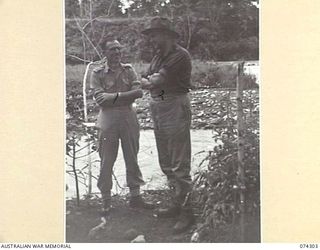 MADANG, NEW GUINEA. 1944-07-27. VX43042 COLONEL J.G. HAYDEN, CBE, ED, COMMANDING OFFICER (1) CHATTING WITH FLIGHT LIEUTENANT R.D. PERKINS, ROYAL AIR FORCE VOLUNTEER RESERVE, MEMBER FOR STROUD IN ..