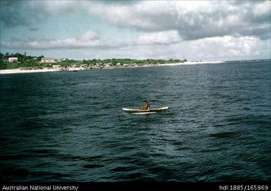 Fisherman on a canoe in the bay