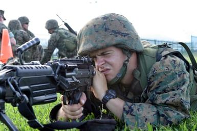 US Marine Corps (USMC) Private (PVT) Cajuvie, Golf Company, 2nd Battalion (BN) 3rd Marine Regiment, sights in his 5.56 mm M249 Squad Automatic Weapon (SAW) while serving as the Squad's SAW gunner during Squad Competitions in preparation for the Super Squad Competition