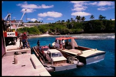 Cars on a barge at wharf, Niue