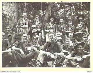 WIDE BAY, NEW BRITAIN. 1945-01-16. TROOPS OF "A" COMPANY, 14/32ND INFANTRY BATTALION RELAXING AND ENJOYING A CUP OF TEA WHILE ON THE TRACK BETWEEN SAMPUN AND KALAMPUN. FOR IDENTIFICATION OF 19 ..