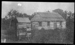 Village dwelling, with outhouse on the left