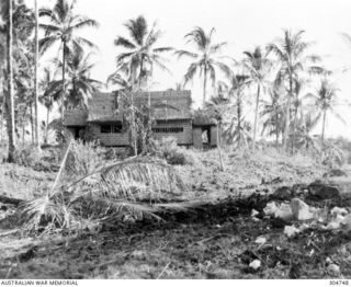 VIRU HARBOUR, NEW GEORGIA, BRITISH SOLOMON ISLANDS PROTECTORATE. THE SCAR OF A NEAR MISS ON THE COASTWATCHER STATION. (NAVAL HISTORICAL COLLECTION)