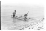 Small outrigger canoe with anthropologists? aboard