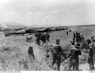 Kaiapit, New Guinea. 1943-09. Australian reinforcements arrive at the airstrip, flown in to assist the 2/6th Independent company AIF who had been attacked by a Japanese force planning to retake ..