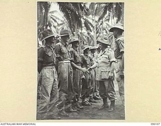 AITAPE, NEW GUINEA. 1945-03-20. GENERAL SIR THOMAS A. BLAMEY, COMMANDER-IN-CHIEF, ALLIED LAND FORCES, SOUTH WEST PACIFIC AREA (6), SHAKING HANDS WITH LIEUTENANT M.M. CROUDACE, 2 BATTERY, 2/1 FIELD ..