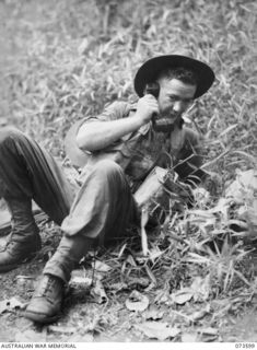 NX120012 Private T J McMahon, 35th Infantry Battalion, maintaining contact with the 8th Infantry Brigade during the drive along the coast towards Wewak