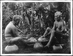 Two Native Hawaiian men grinding taro root for poi, Hawaii