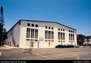 New Caledonia - white building with basketball court-cum-car park