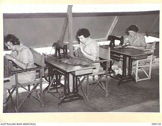 LAE, NEW GUINEA. 1945-11-23. AWAS PERSONNEL USING SEWING MACHINES AT THE DRESSMAKING CLASS HELD AT LAEWAS COLLEGE, AWAS BARRACKS, LAE. IDENTIFIED PERSONNEL ARE: CORPORAL M.I. MCGEE (1); PRIVATE O. ..