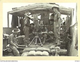 WANDOKAI, NEW GUINEA. 1944-04-22. PERSONNEL OF THE 101ST BRIGADE SUPPORT COMPANY ABOARD A LCM (LANDING CRAFT MECHANIZED) CARRYING A 4.2 INCH MORTAR DURING LANDING TRIALS CONDUCTED BY THE AUSTRALIAN ..
