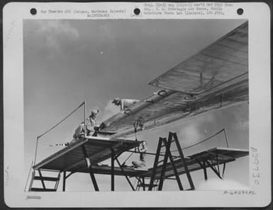 Sheet Metal Wokers Repair Wing Of A Boeing B-29 "Superfortress" Which Was Hit During The First Bombing Mission Over Tokyo, Japan. Saipan, Marianas Islands. November 1944. (U.S. Air Force Number A64290AC)