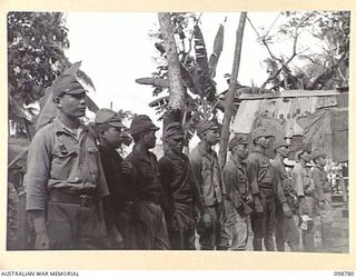 RABAUL, NEW BRITAIN. 1945-11-15. AN IDENTIFICATION PARADE OF SUSPECTED JAPANESE WAR CRIMINALS WAS ARRANGED BY THE WAR CRIMES COMMISSION AT HEADQUARTERS 11 DIVISION. SHOWN, JAPANESE TROOPS LINED UP ..