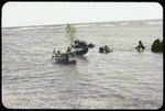 Children in canoes with large leaves