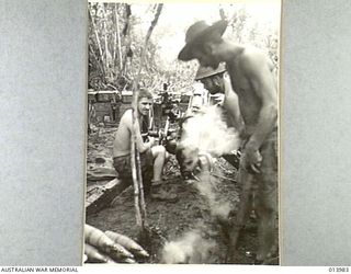 1942-12-05. PAPUA. BUNA. FLASH OF A MOUNTAIN GUN AS IT SHELLS JAPANESE POSITIONS AT BUNA. (NEGATIVE BY G. SILK)
