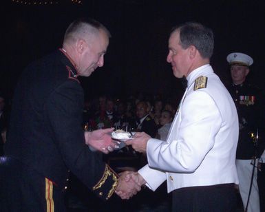 US Marine Corps (USMC) Lieutenant General (LGEN) Wallace Gregson, left, gives a piece of birthday cake to special guest US Navy (USN) Admiral (ADM) Thomas B. Fargo, at the USMC Officer Ball, celebrating the 228th anniversary of the founding of the Marine Corps