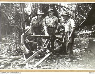 FINSCHHAFEN AREA, NEW GUINEA, 1943-10-28. GUNNERS OF THE 2/2ND AUSTRALIAN MACHINE GUN BATTALION POSE WITH A JAPANESE .5 HEAVY MACHINE GUN WHICH THEY CAPTURED. THEY ARE, LEFT TO RIGHT:- QX8775 ..