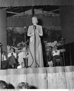 TOROKINA, BOUGAINVILLE, 1945-08-16. GRACIE FIELDS SINGING TO ABOUT 6000 ALLIED TROOPS AT THE GLOUCESTER OVAL THEATRE, HEADQUARTERS 2 CORPS