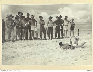 KELANOA, NEW GUINEA, 1944-02-20. SERGEANT GEORGE DOSSEY, OF CALIFORNIA (1), AND CORPORAL CHESTER KILMECK, OF PENNSYLVANIA (2), MEMBERS OF THE UNITED STATES ARMY, IN DIFFICULTIES DURING THE SIAMESE ..