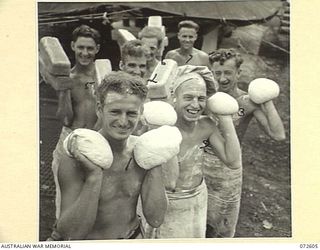 KILIGIA, NEW GUINEA. 1944-04-11. PERSONNEL OF THE 7TH FIELD BAKING PLATOON WITH SAMPLES OF DOUGH AND BREAD PRODUCED FOR UNITS OF THE 5TH AUSTRALIAN DIVISION AT KILIGIA. IDENTIFIED PERSONNEL ARE:- ..