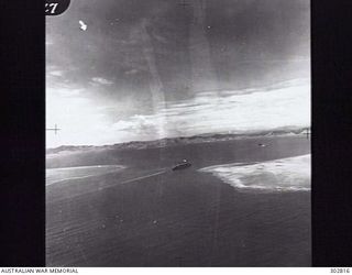 PORT MORESBY, PAPUA NEW GUINEA. 1942-01-03. AERIAL VIEW OF CONVOY ZK5 TURNING TO PORT IN SUCCESSION AS IT ENTERS HARBOUR. SARPEDON LEADS HERSTEIN AND AQUITANIA. (NAVAL HISTORICAL COLLECTION)