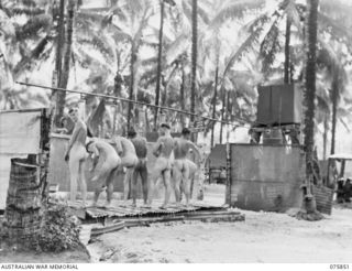 ALEXISHAFEN, NEW GUINEA. 1944-09-13. TROOPS OF THE 133RD BRIGADE WORKSHOPS ENJOYING A CLEAN-UP IN THE UNIT SHOWERS