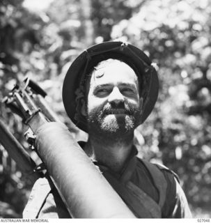 PAPU, NEW GUINEA. 1942-10. PRIVATE R. STEELE OF THE 2/33RD AUSTRALIAN INFANTRY BATTALION WITH HIS MONTH-OLD BEARD, AT MENARI IN THE OWEN STANLEY RANGES