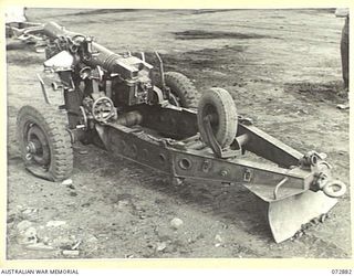 LAE, NEW GUINEA. 1944-05-03. A 25 POUNDER "SHORT" (AUSTRALIAN) MARK I GUN WHICH WAS PARACHUTED INTO THE RAMU VALLEY AND USED BY ARTILLERYMEN OF THE 2/4TH FIELD REGIMENT. THE GUN, IS THE FIRST ..