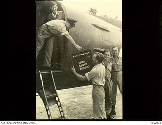 MADANG, NEW GUINEA. C. 1944-10. A BOX OF SPECIAL SOUND RECORDINGS FROM ONE OF THE MAJOR AUSTRALIAN RADIO NETWORKS IS RECEIVED BY 135570 LEADING AIRCRAFTMAN T. C. RICHMOND, NEWCASTLE, NSW, FROM THE ..
