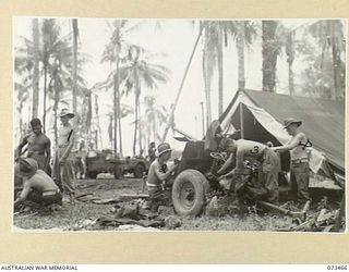 ALEXISHAFEN, NEW GUINEA. 1944-05-23. TROOPS OF THE 30TH INFANTRY BATTALION OVERHAULING THEIR 2 POUNDER TANK ATTACK GUNS SHORTLY AFTER THE WEAPONS HAD BEEN LANDED AT ALEXISHAFEN. IDENTIFIED ..