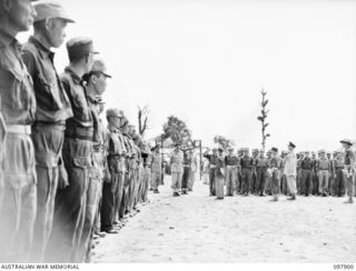 RABAUL, NEW BRITAIN. 1945-10-10. MAJOR GENERAL K.W. EATHER, GENERAL OFFICER COMMANDING 11 DIVISION, BEING MET BY CHINESE OFFICERS AT THE CHINESE ARMY CAMP. A SPECIAL PARADE AND CONCERT WAS HELD AT ..