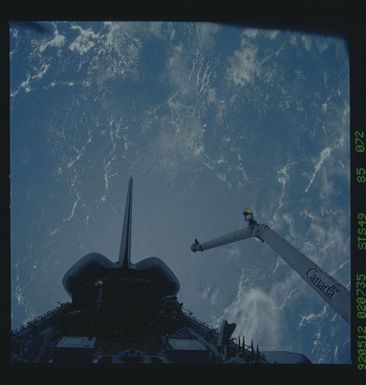 S49-85-072 - STS-049 - Dark views of RMS arm over payload bay