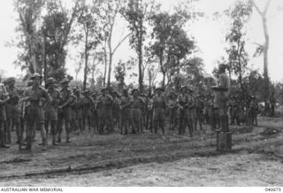 Lieutenant Colonel Albert Caro, Commanding Officer of 2/16th Battalion, 21st Australian Infantry Brigade, addressing his troops before a review of the Brigade by Major General A. S. (Tubby) Allen, ..