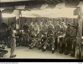 Port Moresby, New Guinea. 1944-06-06. The interior of the gun pit where Chaplain F. M. Hill, of St John's Church of England, holds a Padre's Hour for members of the Paga Paga Battery, Coast ..