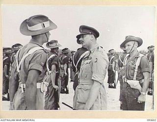 JACQUINOT BAY, NEW BRITAIN, 1945-07-01. HIS ROYAL HIGHNESS, THE DUKE OF GLOUCESTER, GOVERNOR-GENERAL OF AUSTRALIA (2), SPEAKING WITH WARRANT OFFICER 1 R.N. NICHOLLS, REGIMENTAL SERGEANT-MAJOR, ..