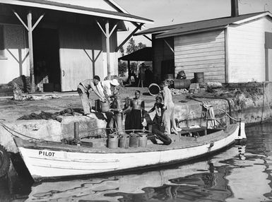 [Men loading the small boat "Pilot"]