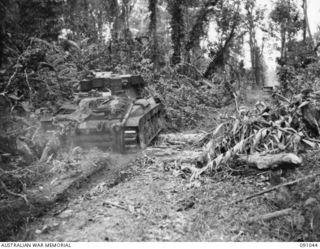 BOUGAINVILLE. 1945-04-18. A MATILDA TANK OF B SQUADRON, 2/4 ARMOURED REGIMENT NEGOTIATING A FALLEN TREE ON BUIN ROAD DURING THE PUSH FORWARD WITH C COMPANY, 24 INFANTRY BATTALION, SOUTH OF DAWE ..