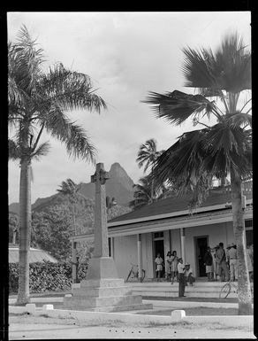 War Memorial, Rarotonga, Cook Islands, includes local people outside a building