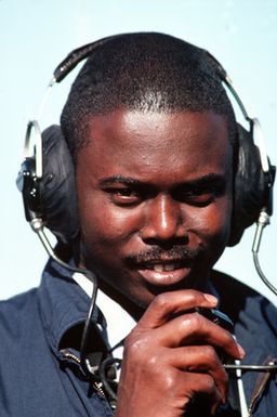 A phone talker operates a sound-powered phone aboard the amphibious assault ship USS GUAM (LPH 9). The ship is operating off the coast of Lebanon