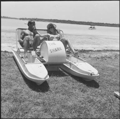 A couple sitting in a paddle boat, New Caledonia, 1967 / Michael Terry