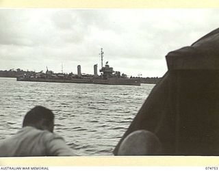 ALEXISHAFEN, NEW GUINEA. 1944. THE COURIER BARGE OF THE 593RD UNITED STATES BARGE COMPANY PASSING A DESTROYER AS THE VESSEL MOVES OUT OF THE HARBOUR ON THE WAY BACK TO MADANG