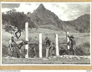 LAKE ROAD, FINISTERRE RANGES, NEW GUINEA. 1943-12-21. MEN OF THE NO. 7 PLATOON, 2/6TH AUSTRALIAN FIELD COMPANY, ROYAL AUSTRALIAN ENGINEERS BUILDING A CULVERT ON THE NEW LAKE ROAD