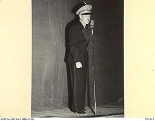 PORT MORESBY, NEW GUINEA. 1944-04-26. QX61809 SERGEANT R.E. STRATH OF THE "DIGGER DANDIES CONCERT PARTY", QUEENSLAND LINES OF COMMUNICATION AREA, ENTERTAINING A LARGE AUDIENCE AT THE PORT MORESBY ..