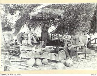 SARANG, NEW GUINEA. 1944-05-25. MEMBERS OF THE 35TH INFANTRY BATTALION RESTING DURING THE DRIVE ALONG THE COAST TOWARDS WEWAK. V503707 PRIVATE C.R. STEVENSON (1); RELAXES ON AN OLD LOUNGE AND ..