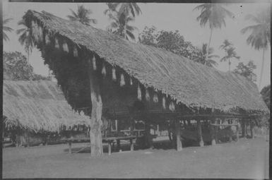 House with tassels hanging from the eaves, Awar, Sepik River, New Guinea, 1935 / Sarah Chinnery