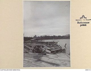 BUNA, NEW GUINEA, 1945-07-03 TO 1945-07-04. THE RUINS OF THE DOCKS AT BUNA BEACH