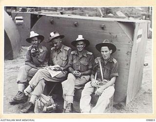 RABAUL, NEW BRITAIN. 1945-11-13. A GROUP OF ROYAL AUSTRALIAN ENGINEERS 11 DIVISION OFFICERS WHO ARE AMONG THE FIRST HIGH PRIORITY PERSONNEL TO DEPART UNDER THE DEMOBILIZATION PLAN. THEY SEEM HAPPY ..